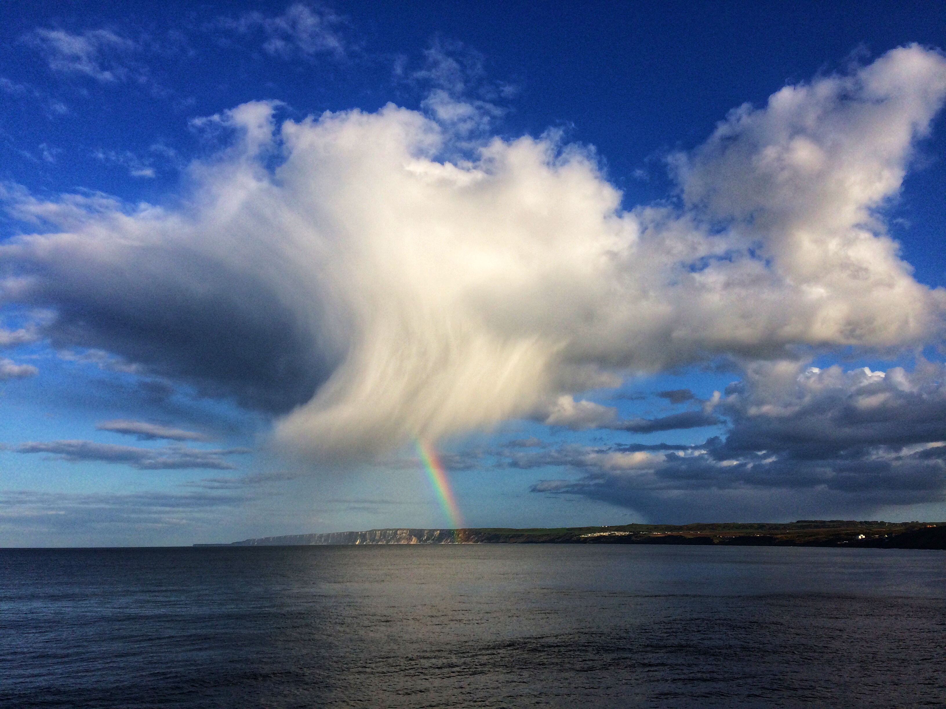 'Fish' cloud and rainbow over Bempton